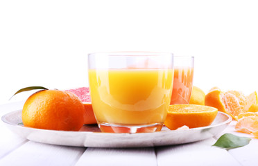 Grapefruit and tangerine juices on wooden table