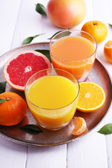 Grapefruit and tangerine juices on wooden table