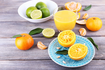 Fototapeta na wymiar Juice and citrus on table close-up