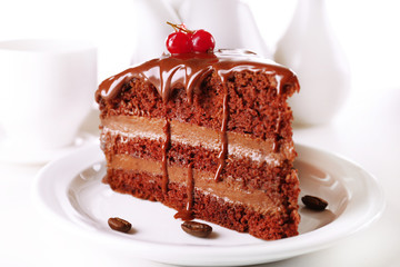 Delicious chocolate cake on plate on table on light background