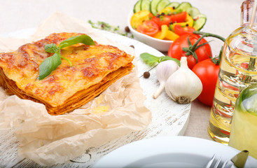 Portion of tasty lasagna on table