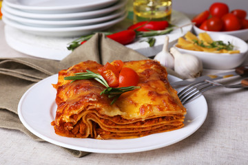 Portion of tasty lasagna on table