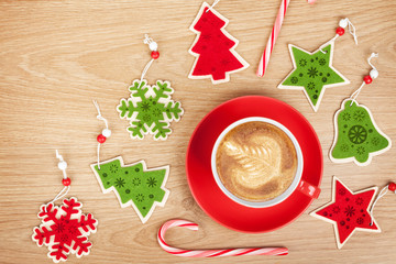 Christmas decor and coffee cup over wooden table background