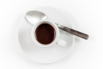 Cup of espresso with spoon on white background, top view