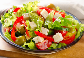 Fresh   salad with feta and olives  .