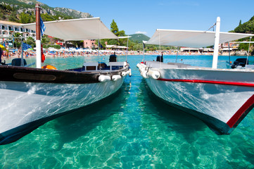 Palaiokastritsa beach with boats on the water. Corfu, Greece.