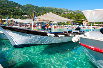 Boats on the water on the Palaiokastritsa beach. Corfu, Greece. - obrazy, fototapety, plakaty