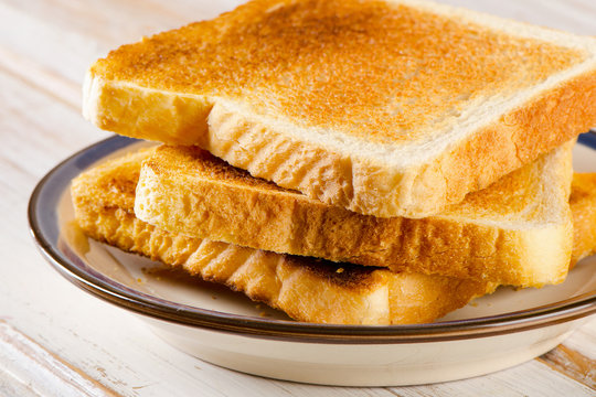 Three  Slices toast bread on wooden background.