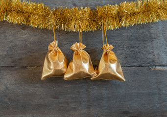 Gifts and tinsel on the wooden background