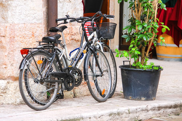 Fototapeta na wymiar Two bicycle stand near an Italian restaurant