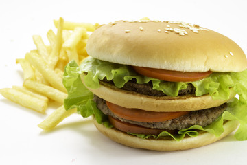 Big hamburger and fried potatoes isolated on white background