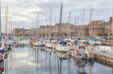 Boats in the port of historical city Saint Malo,  France - obrazy, fototapety, plakaty
