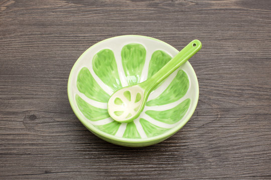 Colored empty bowl on wood background