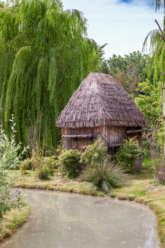 Small hut with a thatched roof.