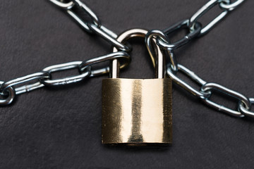 Closeup Of Metallic Padlock And Chains