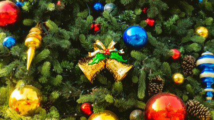 Obraz na płótnie Canvas Decorated christmas tree with colourful christmas ball and gold