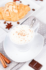 Coffee cup and croissant