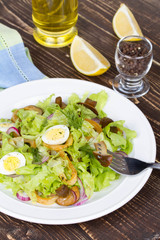 Fresh salad with mushrooms, squid and quail eggs