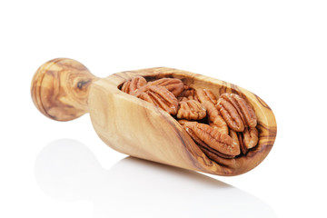 pecan nuts in wood scoop