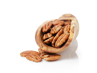 pecan nuts in wood scoop
