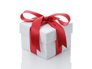 white gift box with red ribbon bow