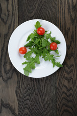 arugula and cherry tomatoes on plate