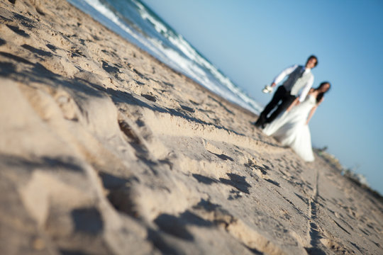 newlywed couple on the beach