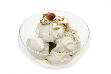 Pistachio ice cream in bowl on white background