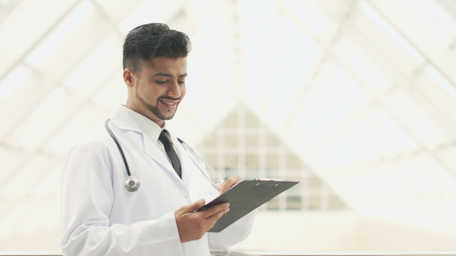 The indian doctor make note to the pad