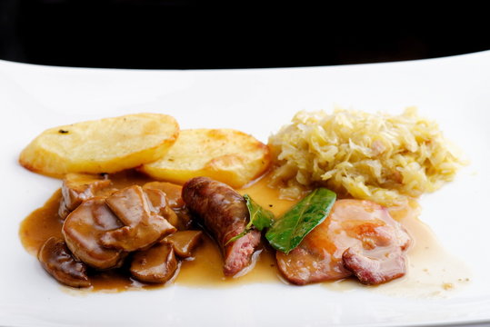 German food,  with sausages, steaks, potato and cabbage