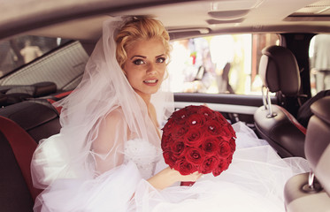 Beautiful bride smile in a luxury car