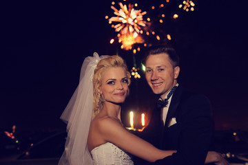 Beautiful bridal couple dancing sorrounded by fireworks