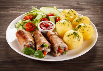 Wrapped pork chop, boiled potatoes and vegetables