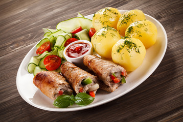 Wrapped pork chop, boiled potatoes and vegetables