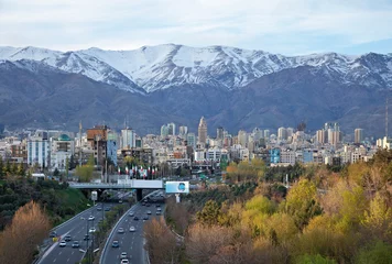 Fototapeten Tehran Skyline and Highway in Front of Snowy Mountains © Borna_Mir