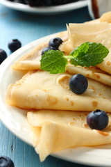 Homemade crepes with blueberries, chocolate sauce