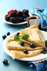 Homemade crepes with blueberries, chocolate sauce
