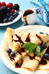 Homemade crepes with blueberries, chocolate sauce