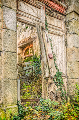 Fototapeta na wymiar Broken door and medieval abandoned house in village