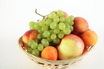 Fruit basket with apple peach grape and apricot