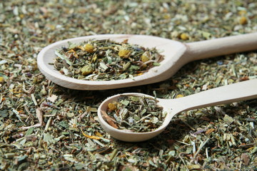 Wooden spoon and various herbs in a herbalist