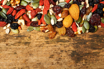 mix nuts seeds and dry fruits, on a wooden table