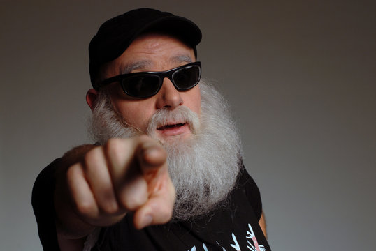 B&auml;rtiger Mann mit sonnenbrille zeigt auf sein gegen&uuml;ber