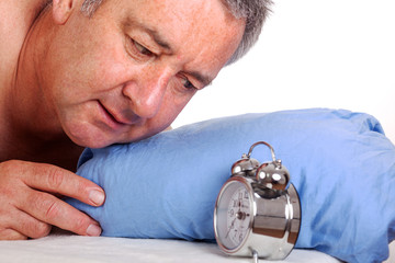 Man can not sleep and looked at the alarm clock