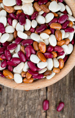 various beans in a wooden bowl