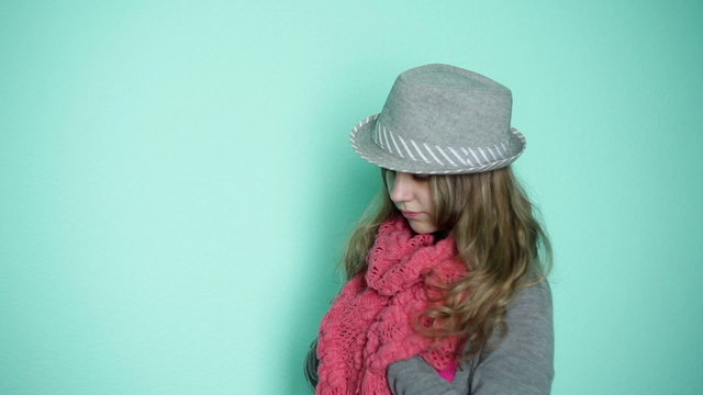 beautiful girl in a hat with a pink scarf