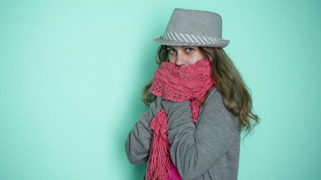 beautiful girl in a hat with a pink scarf