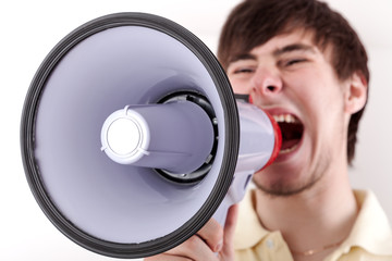 Young man shouting into the megaphone