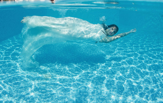 Beautiful woman  swiming underwater