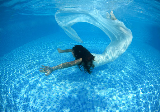 Beautiful woman swiming underwater